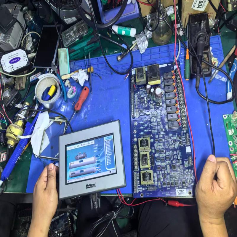 The technician is repairing and commissioning the McQuay inverter main drive board of compressor